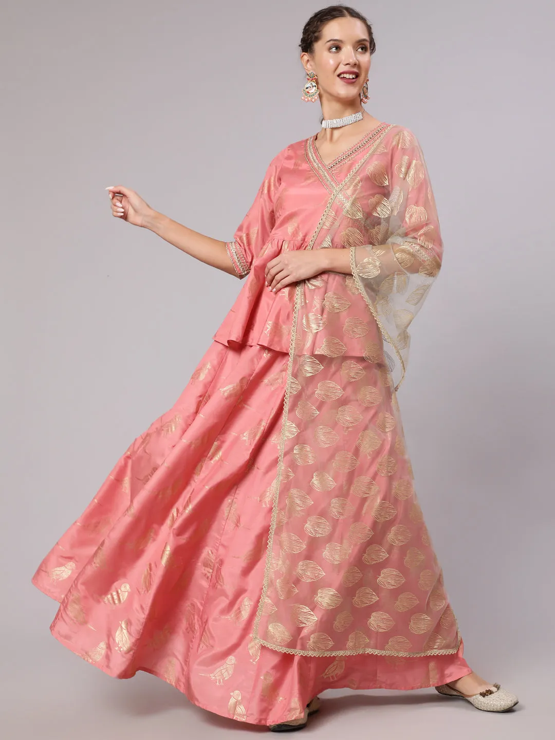 A Peach Color Bird Printed Silk Blend Peplum Top And Skirt With A Gold Print Net Dupatta